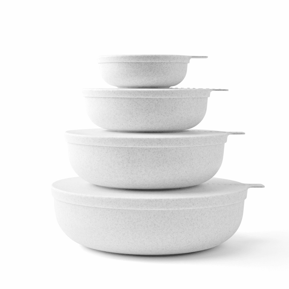 Stacking bowls with lids in a stony speckle finish.