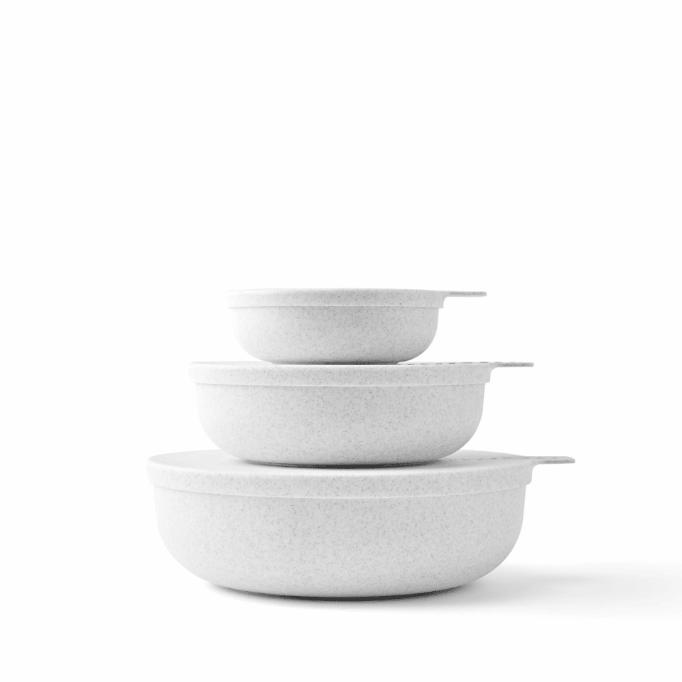Stacking bowls with lids in a stony speckle finish.